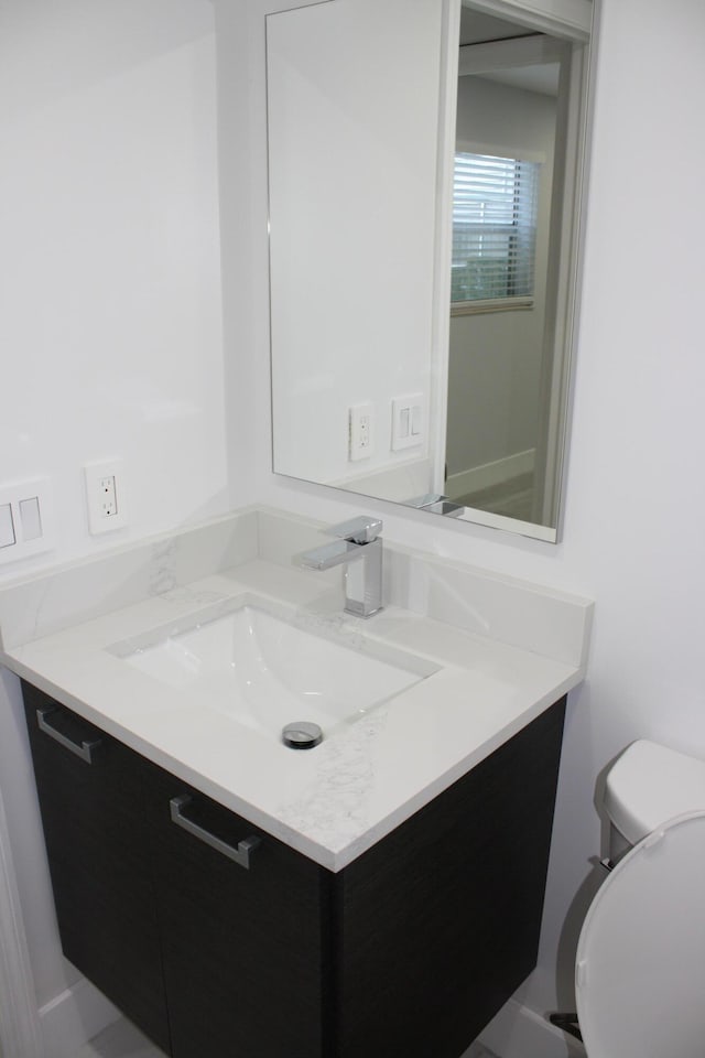 bathroom with vanity and toilet