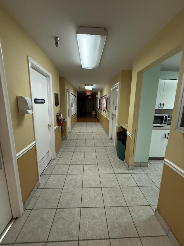 corridor with light tile patterned floors