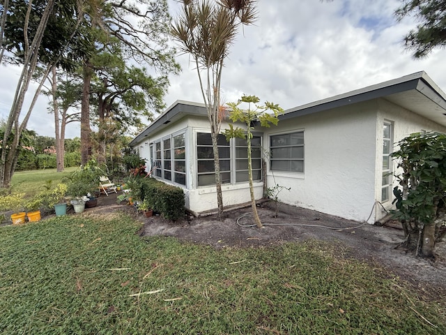 view of property exterior with a yard