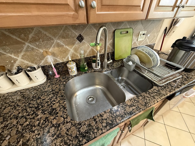 details featuring dark stone countertops and sink