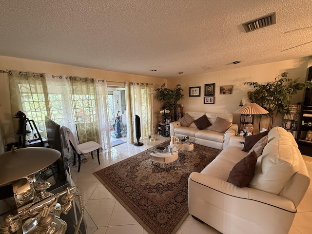 living room featuring light tile patterned floors and a textured ceiling