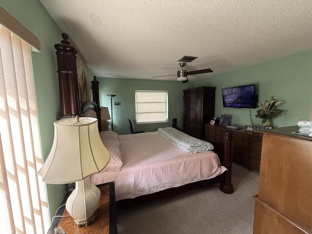 bedroom featuring ceiling fan, carpet, and a textured ceiling