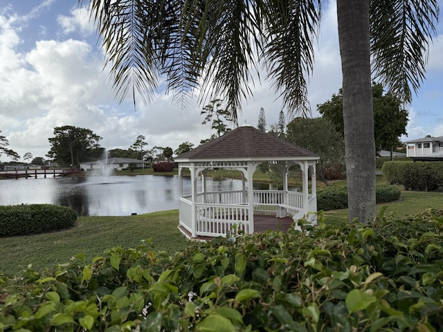 view of dock with a gazebo and a water view