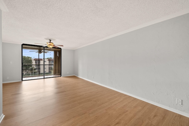 unfurnished room with a textured ceiling, light hardwood / wood-style flooring, and ornamental molding