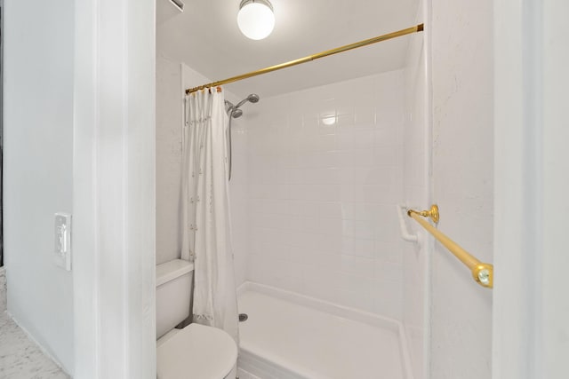 bathroom with a shower with curtain and toilet