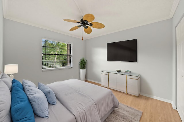 bedroom featuring ceiling fan, light hardwood / wood-style floors, and ornamental molding