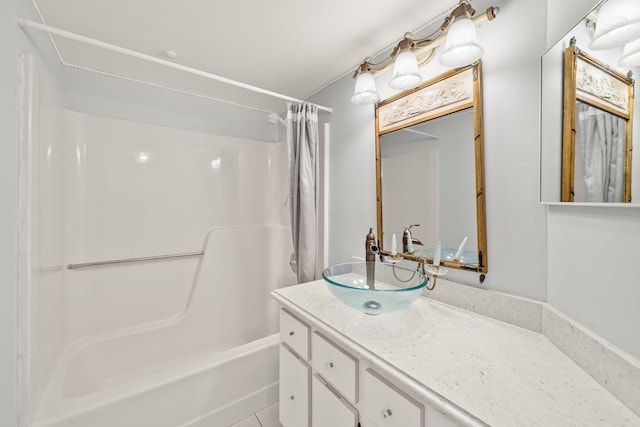 bathroom with tile patterned flooring, vanity, and shower / bath combo with shower curtain