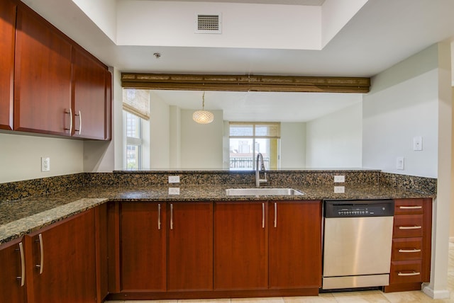 kitchen with a healthy amount of sunlight, dishwasher, and dark stone counters