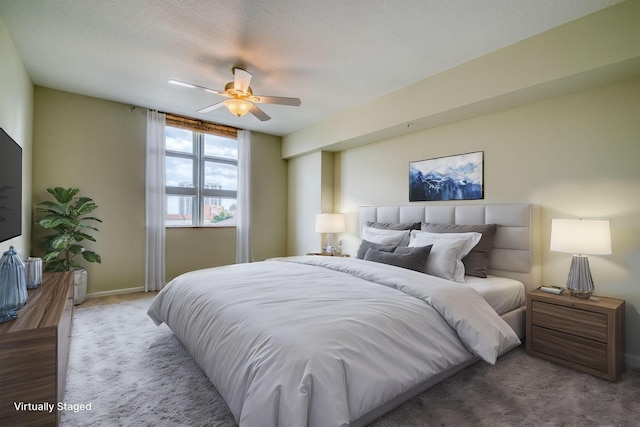 bedroom with carpet, ceiling fan, and a textured ceiling