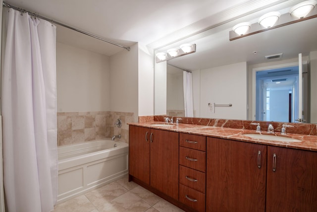 bathroom with tile patterned floors, vanity, and a bathing tub