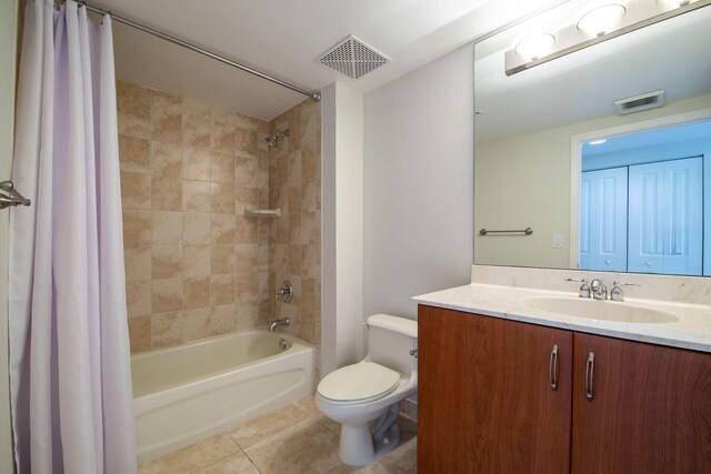 full bathroom featuring tile patterned floors, shower / bath combo with shower curtain, vanity, and toilet