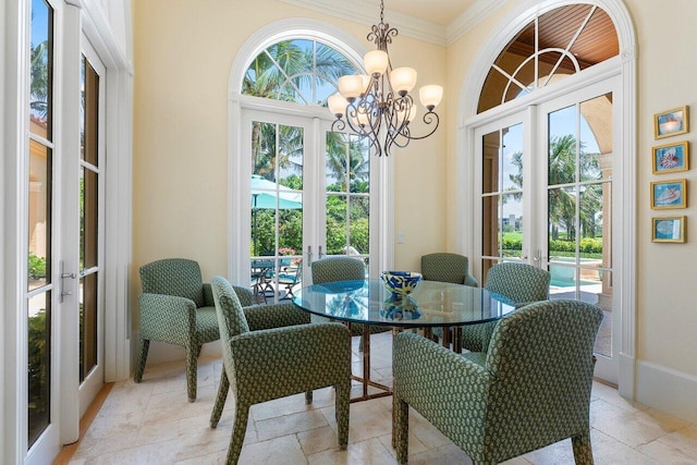 dining room featuring a chandelier, french doors, crown molding, and a healthy amount of sunlight