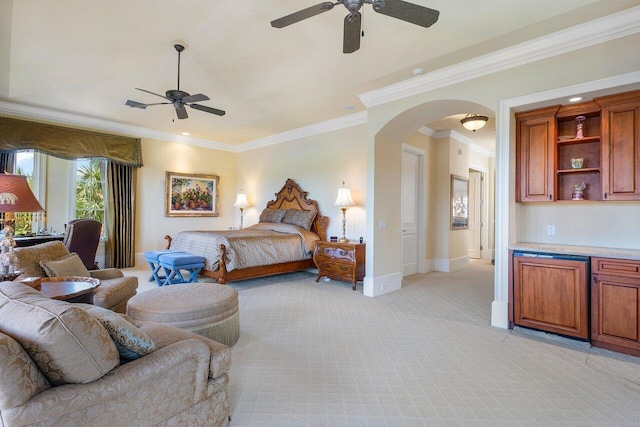 carpeted bedroom featuring ceiling fan and crown molding