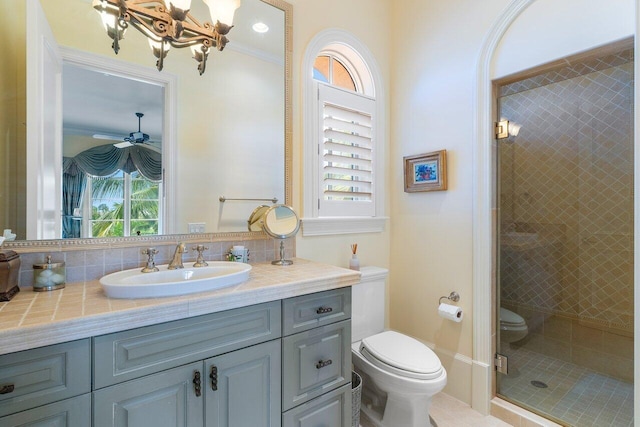 bathroom featuring an enclosed shower, toilet, a wealth of natural light, and ceiling fan