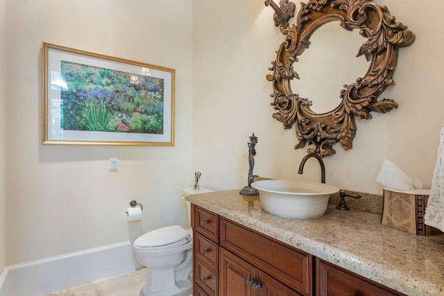 bathroom featuring tile patterned floors, vanity, and toilet