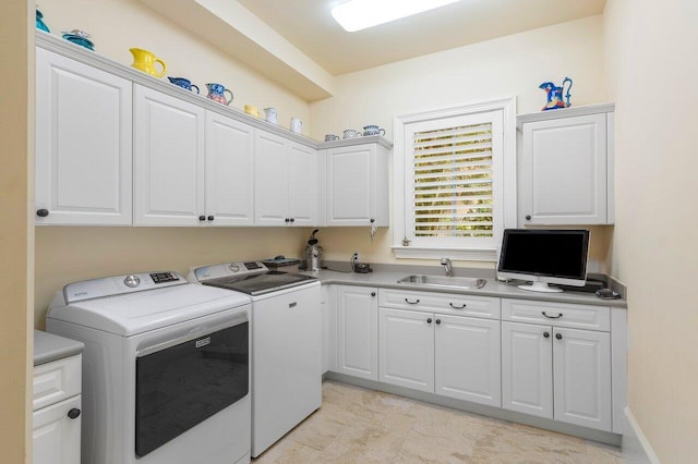 laundry room with separate washer and dryer, sink, and cabinets