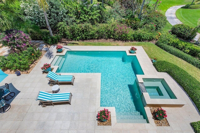 view of swimming pool featuring a patio area and an in ground hot tub