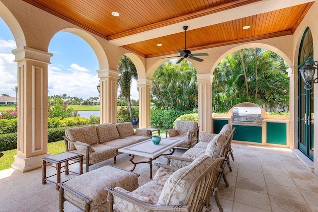 view of patio with an outdoor living space, area for grilling, and ceiling fan