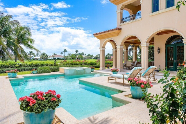 view of swimming pool with an in ground hot tub and a patio area