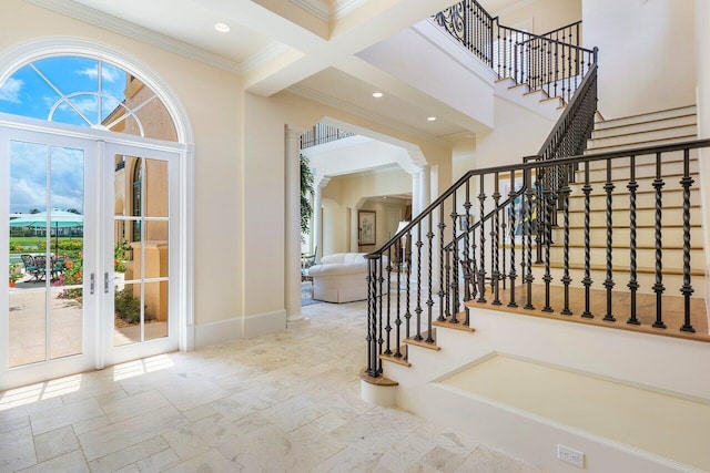 entrance foyer with beam ceiling, french doors, coffered ceiling, decorative columns, and crown molding