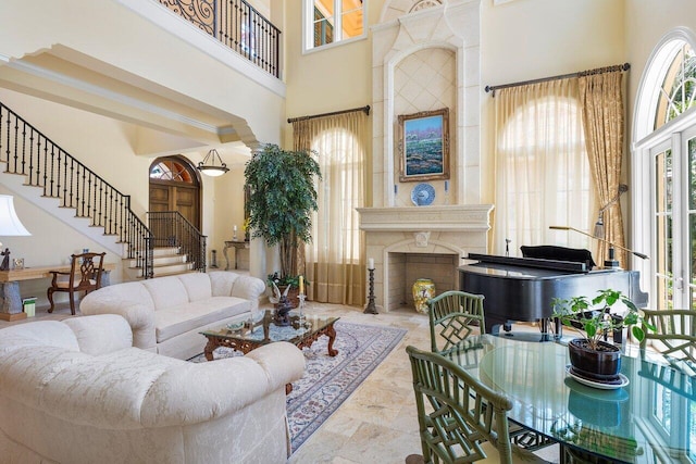 living room featuring crown molding and a high ceiling