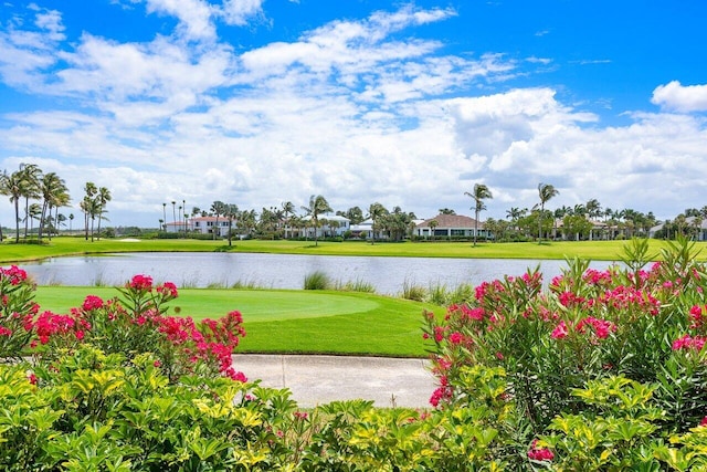 view of property's community with a yard and a water view