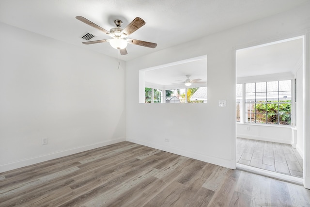 unfurnished room with light hardwood / wood-style flooring and ceiling fan