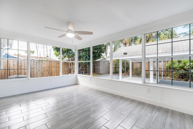 unfurnished sunroom with plenty of natural light and ceiling fan