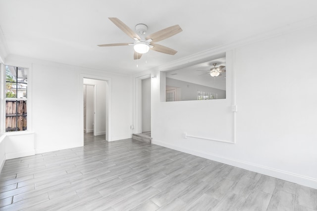 unfurnished room featuring light wood-type flooring, ceiling fan, and crown molding