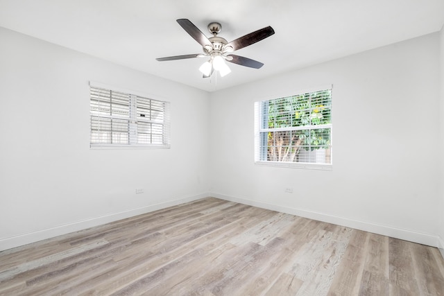 unfurnished room featuring ceiling fan, light hardwood / wood-style flooring, and a healthy amount of sunlight