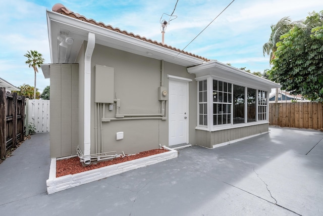 1609 N J Ter, Lake Worth, FL 33460 - doorway to property featuring a patio area and a tile roof