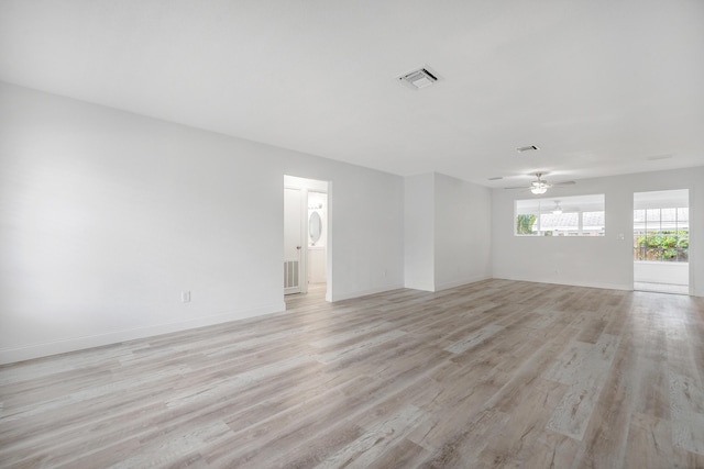 empty room featuring ceiling fan and light hardwood / wood-style floors