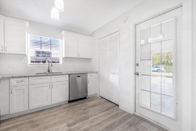 kitchen with stainless steel dishwasher, white cabinetry, sink, and light hardwood / wood-style flooring