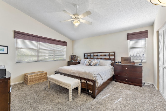 bedroom with ceiling fan, a closet, and light carpet