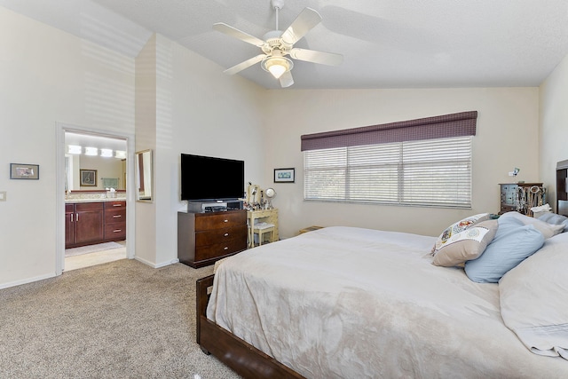 bedroom with ceiling fan, ensuite bathroom, light colored carpet, a textured ceiling, and lofted ceiling