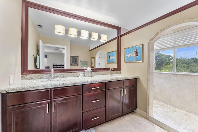 bathroom featuring tile patterned floors, vanity, ceiling fan, and a shower