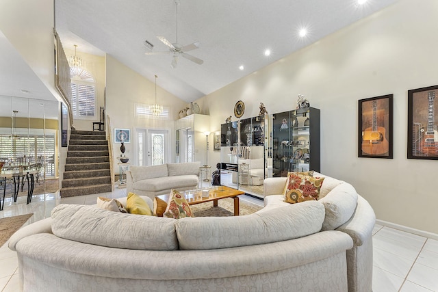 living room featuring light tile patterned floors, ceiling fan with notable chandelier, a textured ceiling, and high vaulted ceiling