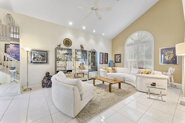 living room with ceiling fan, light tile patterned floors, a textured ceiling, and high vaulted ceiling