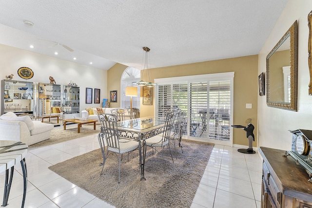 tiled dining space with a textured ceiling