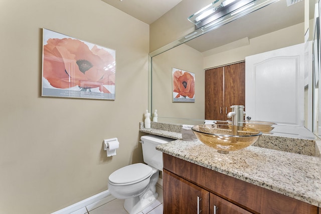 bathroom featuring tile patterned flooring, vanity, and toilet