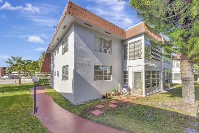 view of side of property with a lawn