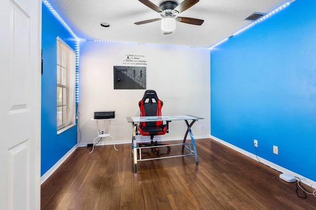 office area with a textured ceiling, hardwood / wood-style flooring, and ceiling fan