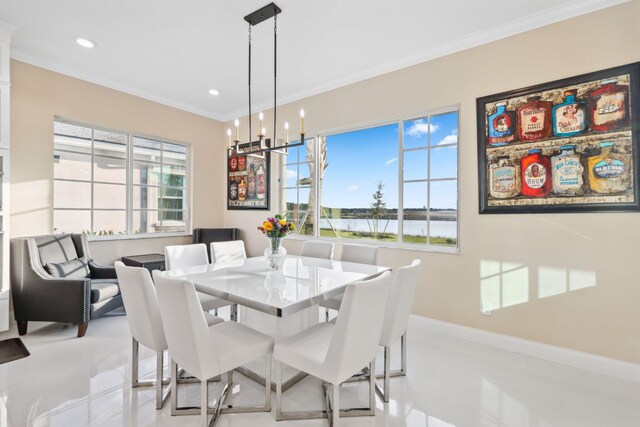 kitchen featuring a center island, white cabinets, a water view, crown molding, and hanging light fixtures