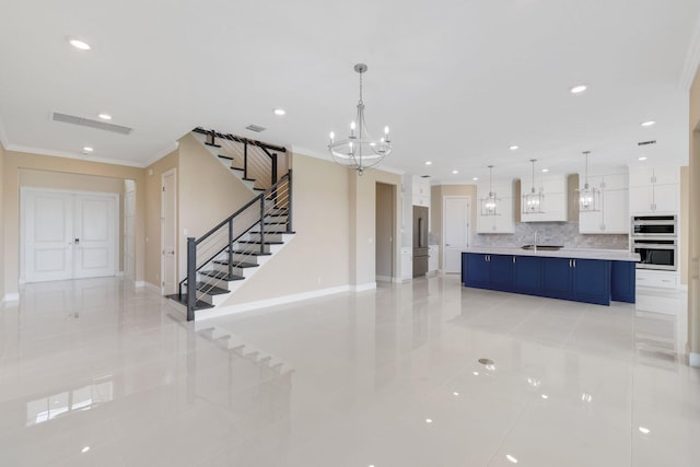 interior space featuring light tile patterned flooring, ornamental molding, and a notable chandelier