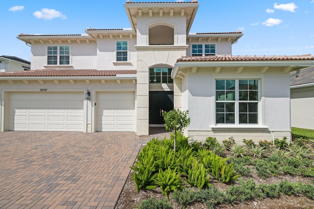 mediterranean / spanish house with a garage