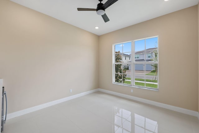 unfurnished room featuring ceiling fan and light tile patterned floors