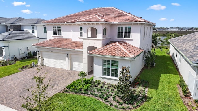 mediterranean / spanish home with a front yard and a garage