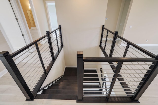 stairs with hardwood / wood-style floors