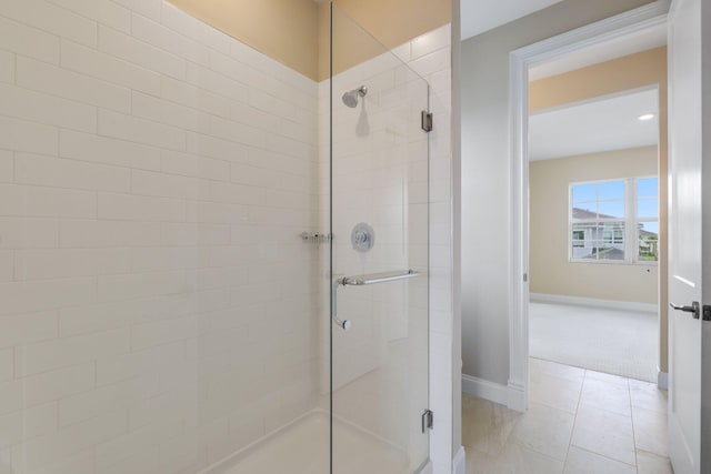 bathroom with tile patterned floors and a shower with shower door