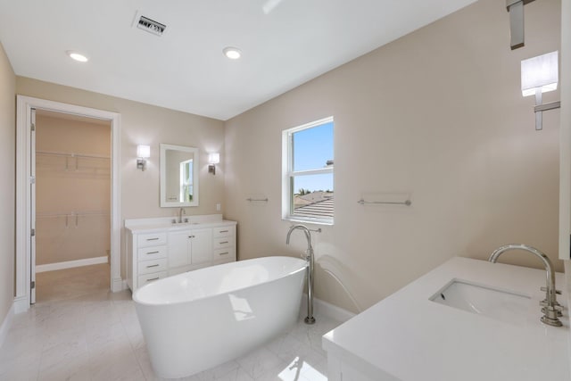 bathroom featuring vanity and a bath